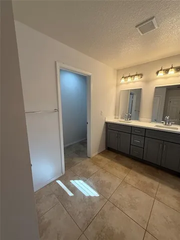 a spacious bathroom with a tub sink and mirror