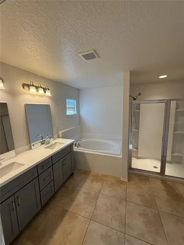 an empty room with windows and ceiling fan