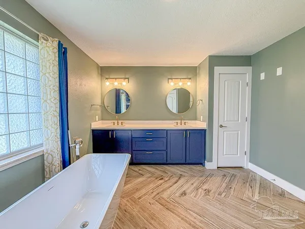 a large kitchen with a large counter top stainless steel appliances and cabinets