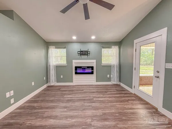 wooden floor in an empty room with a window