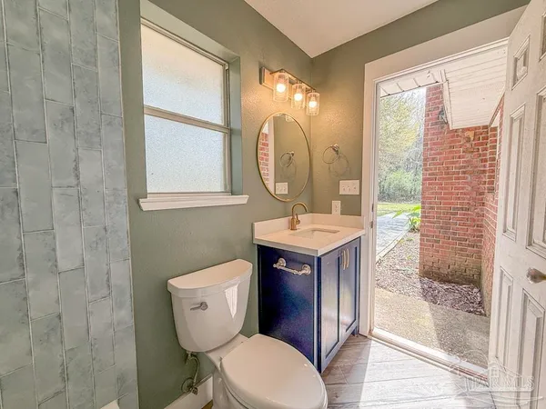 a bathroom with a sink a toilet and a mirror