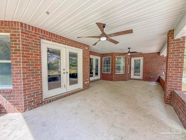 a front view of house with yard and trees around