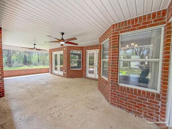 a view of a house with a yard and trees