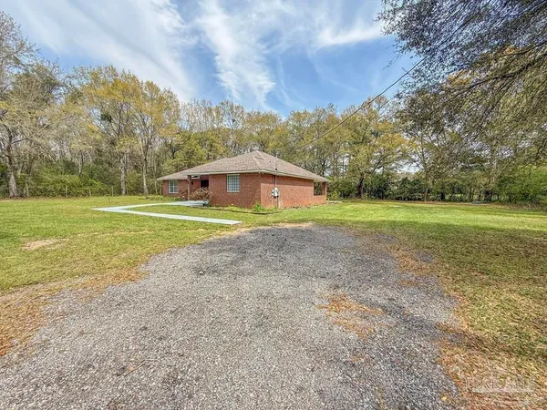 a view of a lake with large trees