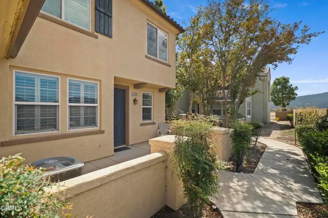 a view of a house with backyard and sitting area