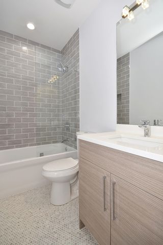 a kitchen with stainless steel appliances kitchen island granite countertop a stove a refrigerator and a view of living room