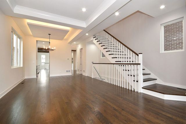 a view of kitchen with granite countertop cabinets and window