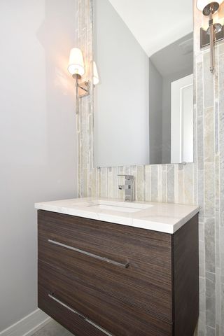 a bathroom with a tub sink and mirror