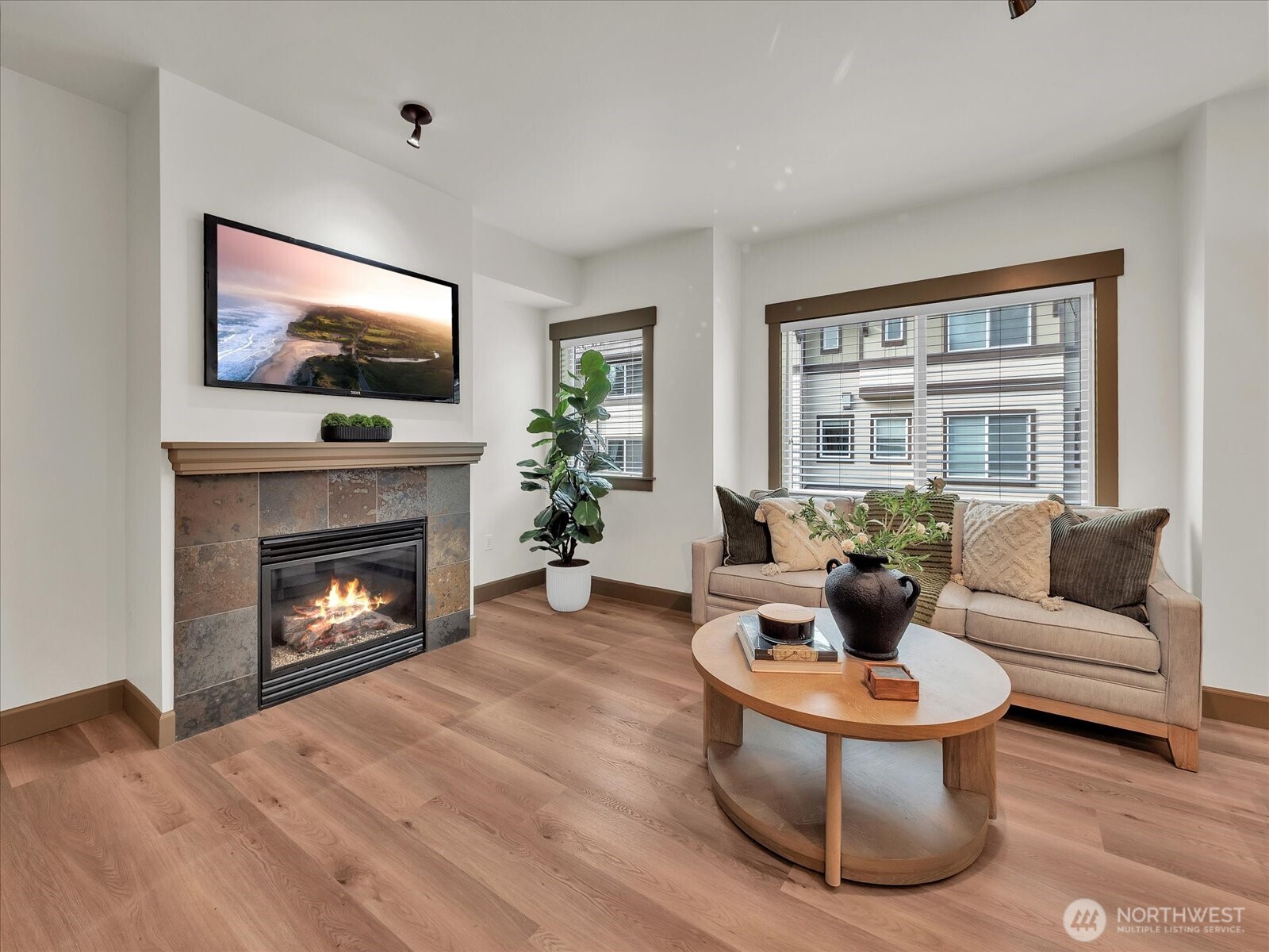 2115 201st Place Southeast, Unit K2 Bothell, WA 98012 - Photo 6 of 28 a living room with furniture a fireplace and a flat screen tv