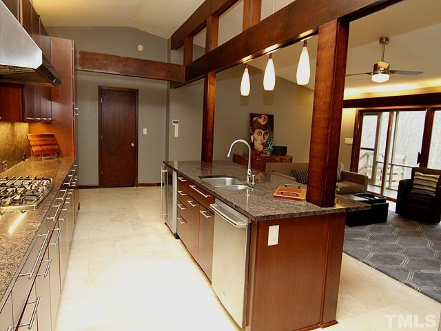 4901 Rembert Drive Raleigh, NC 27612 - Photo 8 of 25 A large kitchen with travertine flooring, stainless steel appliances, gas cook top, double oven, new cabinets, lots of interesting lighting and a skylight for natural light. Welcome chef's. Kitchen