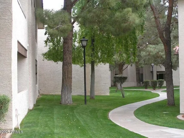 a view of a house with a backyard