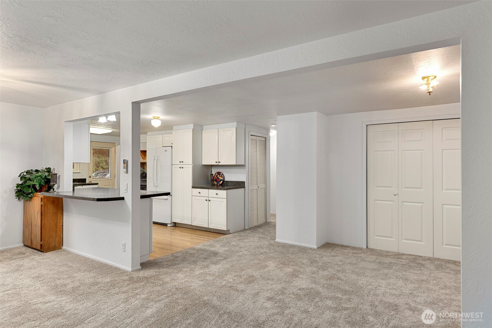 26009 Barrett Road Northeast Kingston, WA 98346 - Photo 11 of 25 a view of a kitchen with refrigerator stove and cabinets