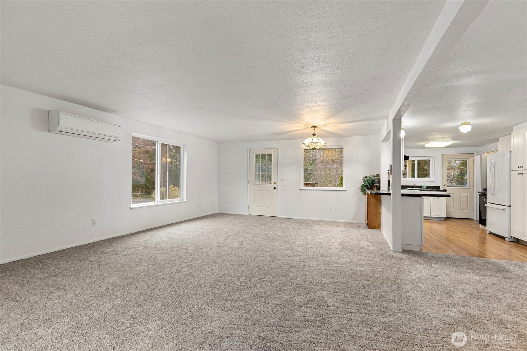 26009 Barrett Road Northeast Kingston, WA 98346 - Photo 13 of 25 a view of a big room with windows and chandelier