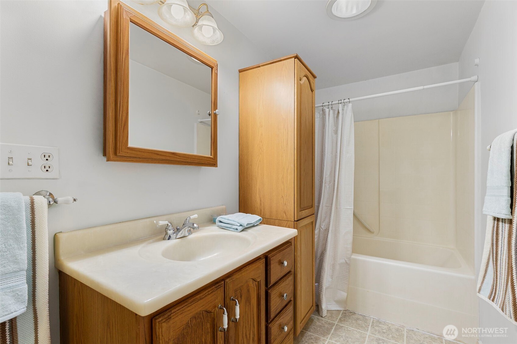 26009 Barrett Road Northeast Kingston, WA 98346 - Photo 19 of 25 a bathroom with a sink vanity tub and a mirror
