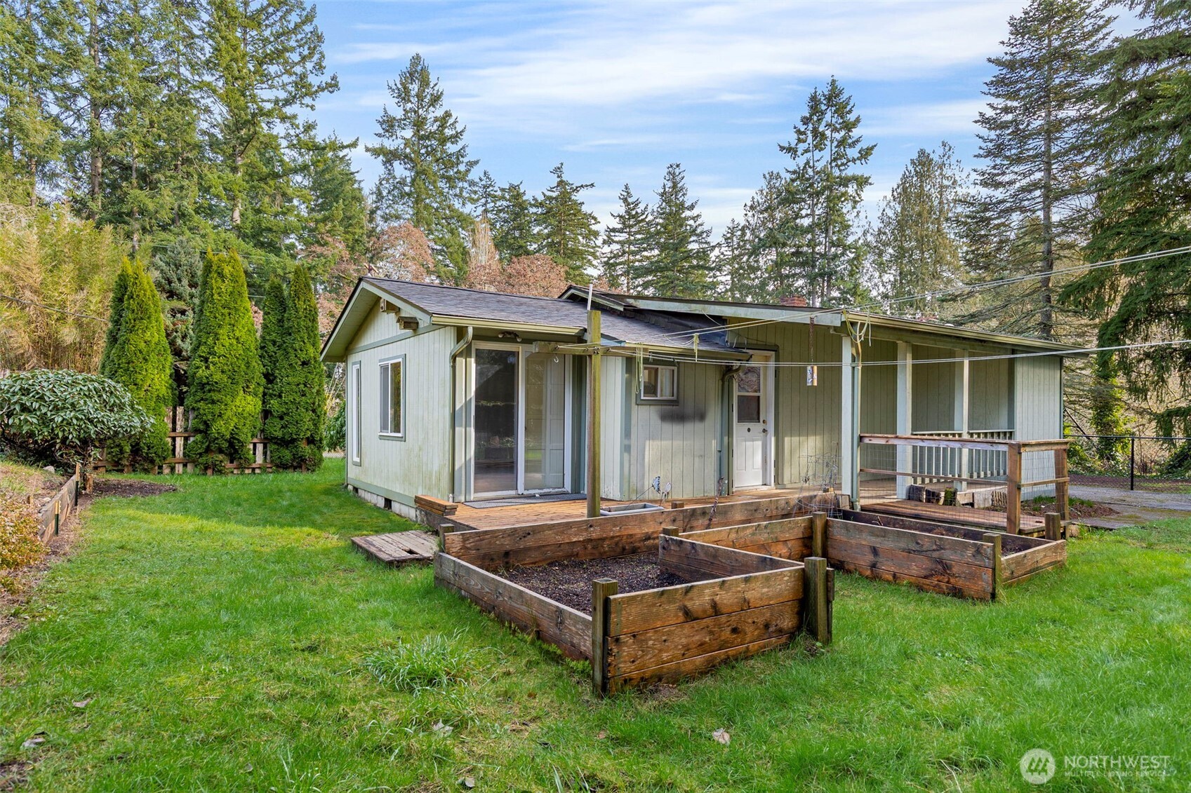 26009 Barrett Road Northeast Kingston, WA 98346 - Photo 3 of 25 a backyard of a house with table and chairs