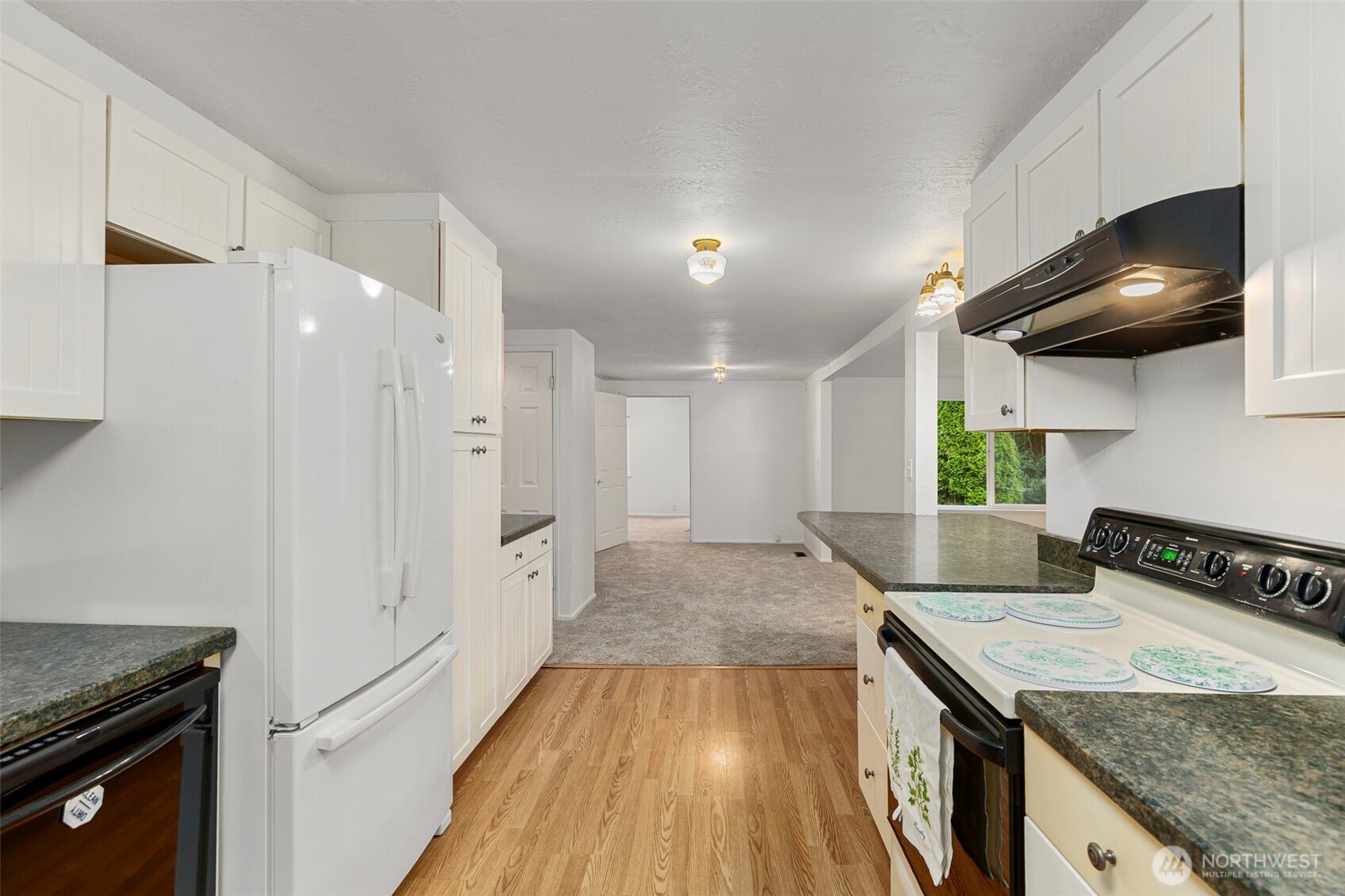 26009 Barrett Road Northeast Kingston, WA 98346 - Photo 7 of 25 a kitchen with granite countertop a stove and a sink