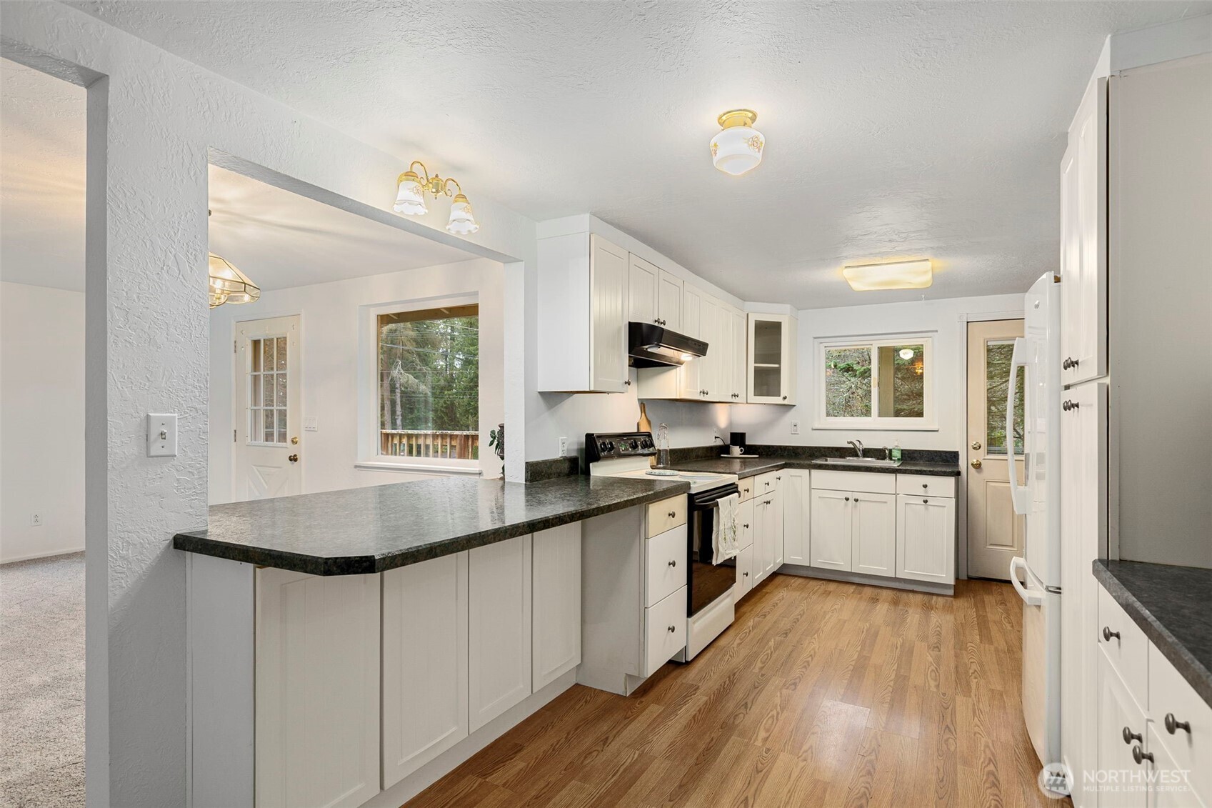 26009 Barrett Road Northeast Kingston, WA 98346 - Photo 9 of 25 a kitchen with sink stove and refrigerator