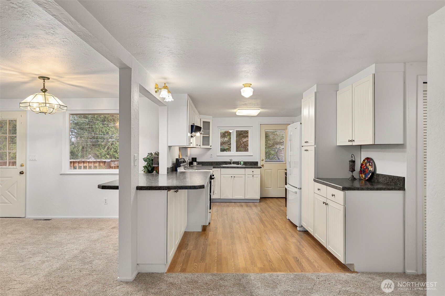 26009 Barrett Road Northeast Kingston, WA 98346 - Photo 10 of 25 a kitchen with white cabinets and sink