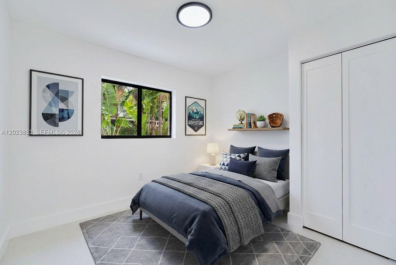 6566 Southwest 35th Street Miami, FL 33155 - Photo 19 of 36 a bedroom with a bed and a window