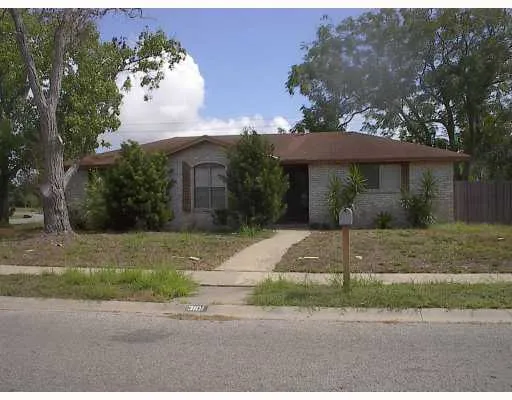 a front view of a house with a yard and a garage