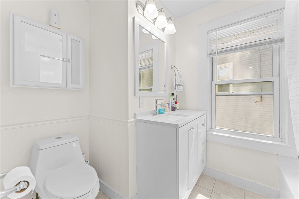 14 Glendale Street, Unit 14 Maynard, MA 01754 - Photo 17 of 29 a bathroom with a sink vanity mirror and toilet