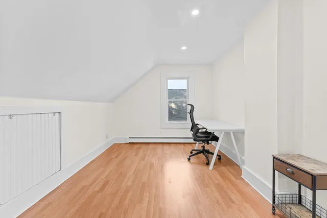 a view of a room with wooden floor and benches
