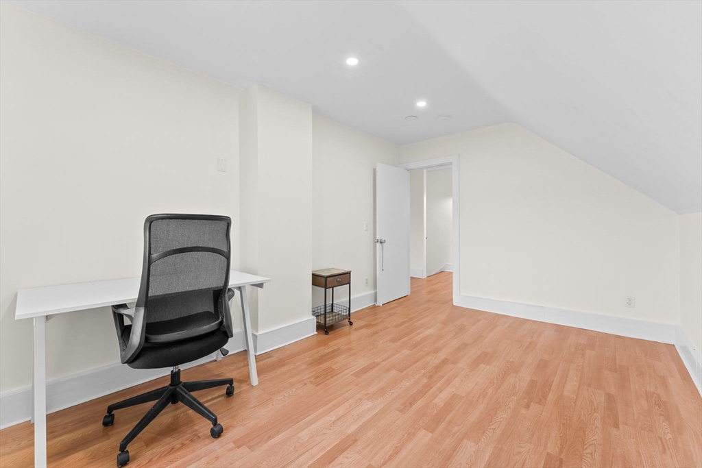 14 Glendale Street, Unit 14 Maynard, MA 01754 - Photo 25 of 29 a room with a chair and a wooden floor