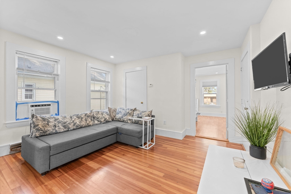14 Glendale Street, Unit 14 Maynard, MA 01754 - Photo 3 of 29 a living room with furniture a flat screen tv and a potted plant