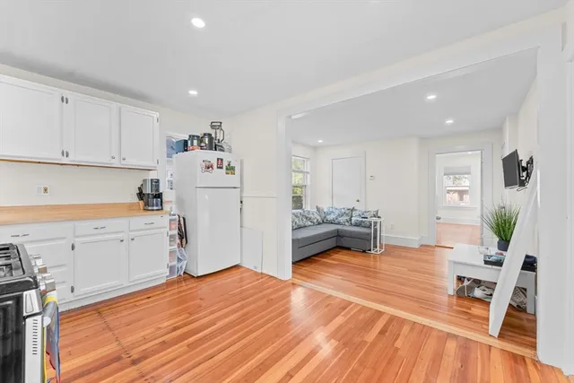 a view of a kitchen with sink and wooden floor