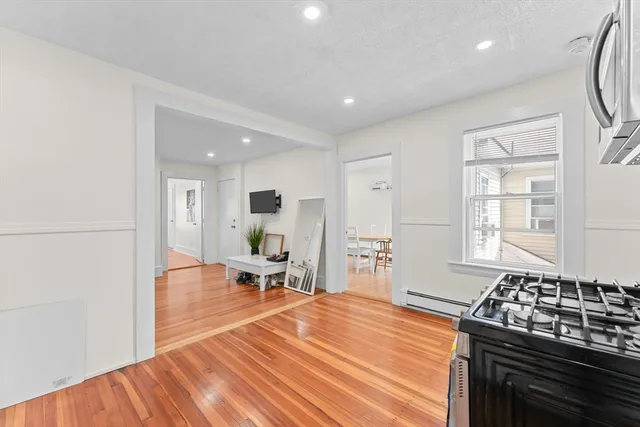 a large kitchen with stainless steel appliances a large counter top a stove and a refrigerator