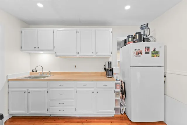 a white refrigerator freezer sitting inside of a kitchen