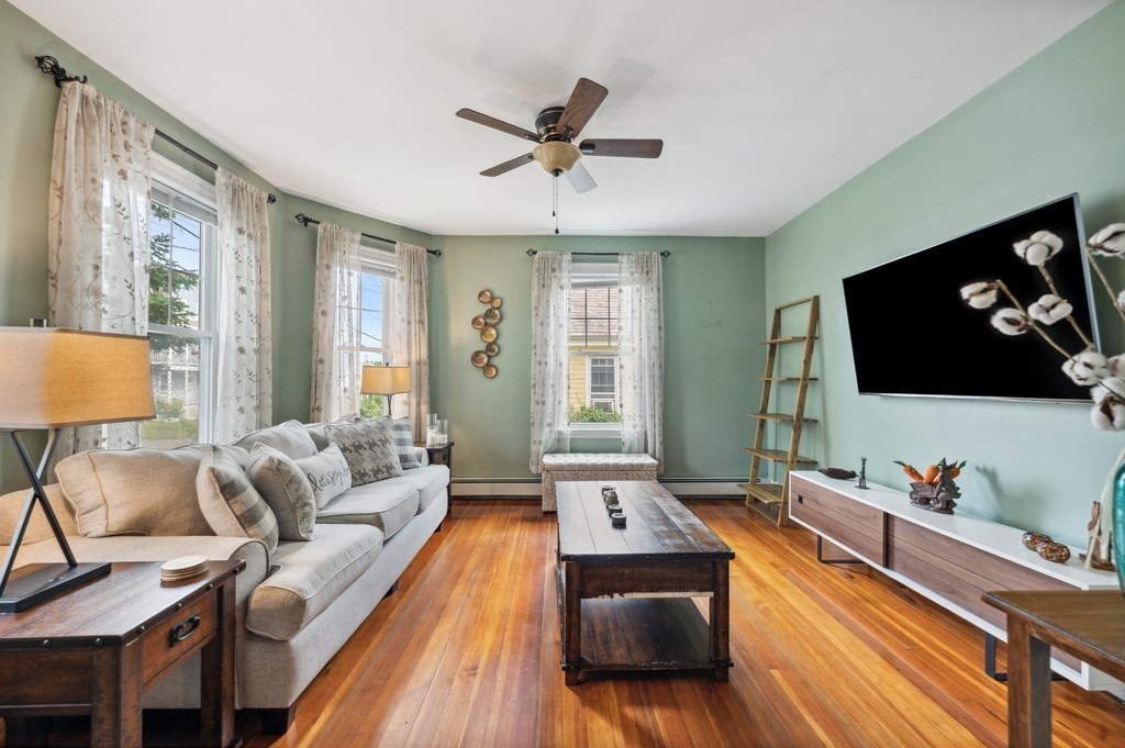 73 Cranch Street, Unit 73 Quincy, MA 02169 - Photo 2 of 22 a living room with furniture and a flat screen tv