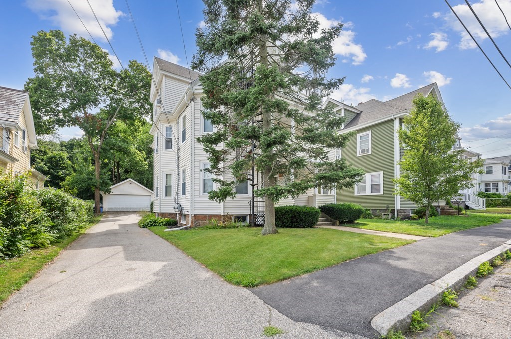 73 Cranch Street, Unit 73 Quincy, MA 02169 - Photo 22 of 22 a front view of a house with a yard and trees