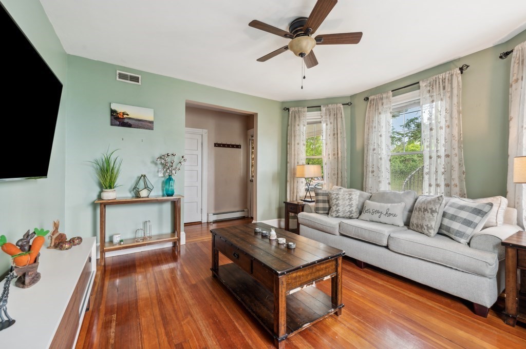 73 Cranch Street, Unit 73 Quincy, MA 02169 - Photo 4 of 22 a living room with furniture and a flat screen tv