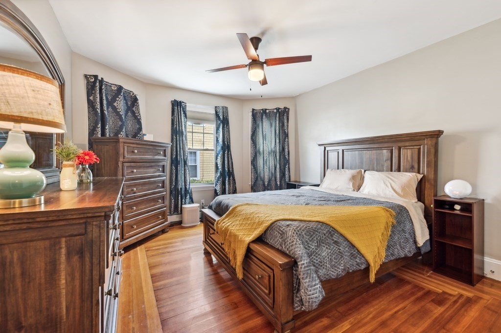 73 Cranch Street, Unit 73 Quincy, MA 02169 - Photo 7 of 22 a bedroom with a bed and wooden floor