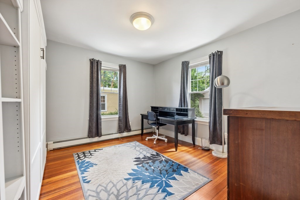 73 Cranch Street, Unit 73 Quincy, MA 02169 - Photo 9 of 22 a view of a workspace with wooden floor and a window
