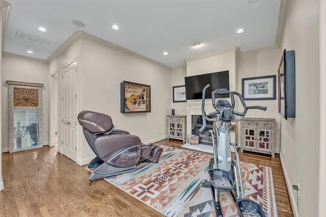 a living room with furniture a rug and a flat screen tv