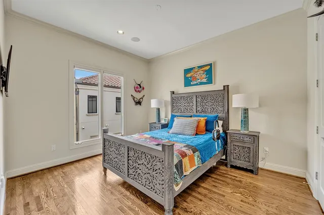 a bedroom with a bed and a painting on the wall