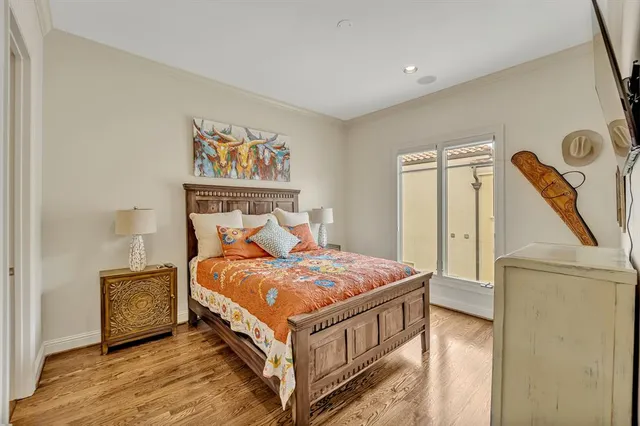 a bed sitting in a bedroom next to a cabinet