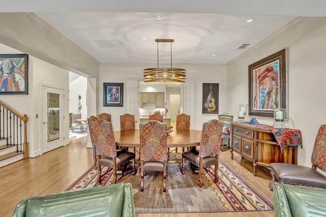 a view of a dining room with furniture wooden floor and chandelier