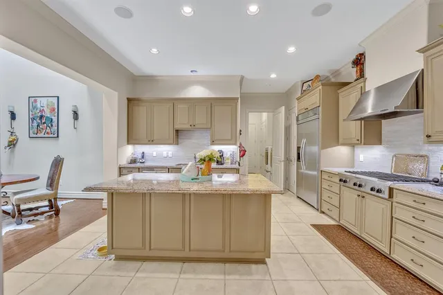 a kitchen with cabinets and chairs