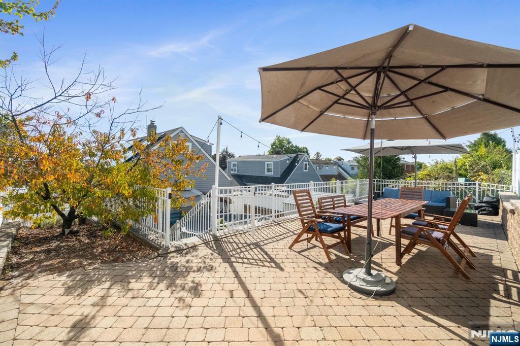 340 Marsan Drive Carlstadt, NJ 07072 - Photo 14 of 50 a view of a patio with table and chairs under an umbrella