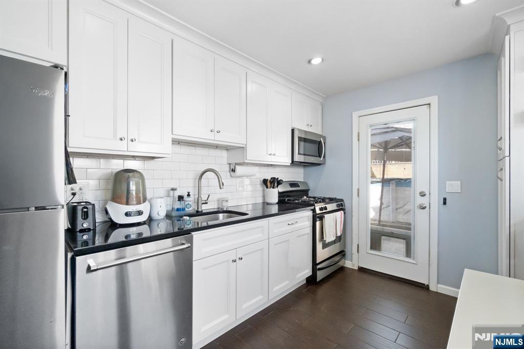 340 Marsan Drive Carlstadt, NJ 07072 - Photo 3 of 50 a kitchen with stainless steel appliances granite countertop a refrigerator sink and cabinets