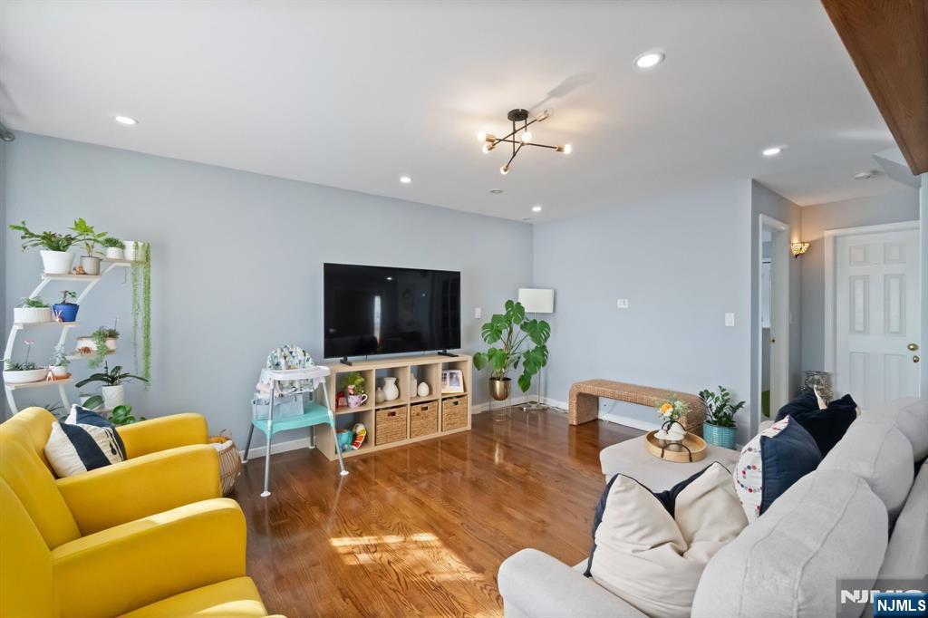 340 Marsan Drive Carlstadt, NJ 07072 - Photo 32 of 50 a living room with furniture and a flat screen tv