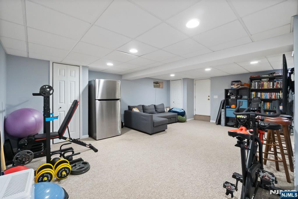 340 Marsan Drive Carlstadt, NJ 07072 - Photo 34 of 50 a room with gym equipment and a flat screen tv