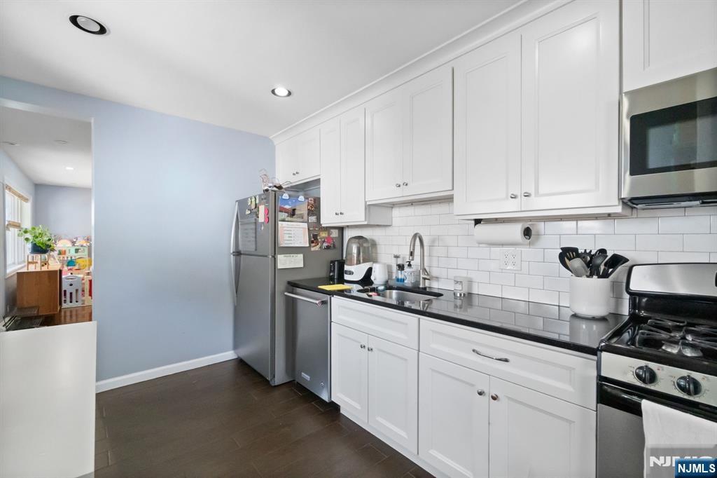 340 Marsan Drive Carlstadt, NJ 07072 - Photo 37 of 50 a kitchen with stainless steel appliances granite countertop a refrigerator sink and stove