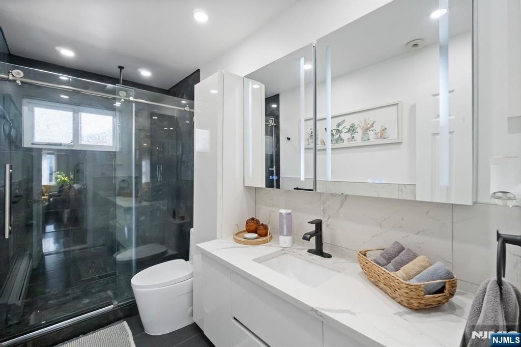 340 Marsan Drive Carlstadt, NJ 07072 - Photo 4 of 50 a bathroom with a sink toilet and shower