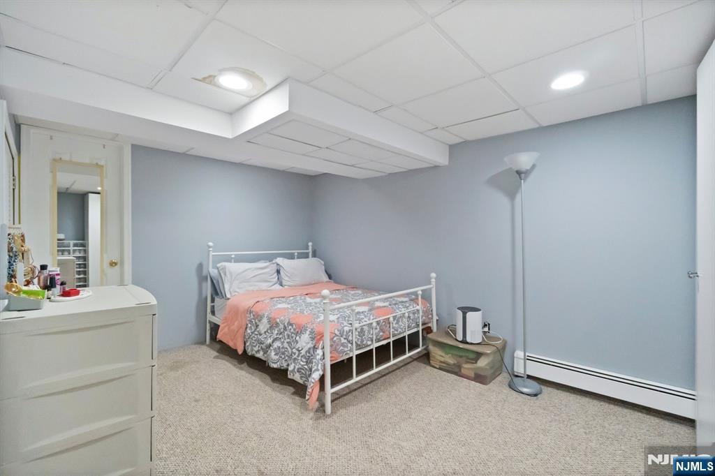 340 Marsan Drive Carlstadt, NJ 07072 - Photo 9 of 50 a bedroom with a bed and a dresser