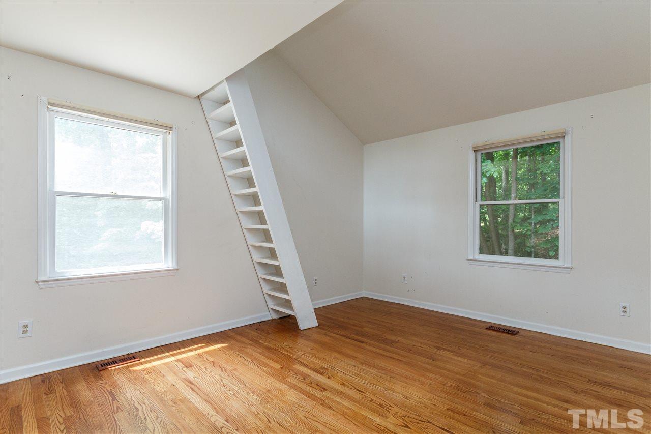11604 Black Horse Run Raleigh, NC 27613 - Photo 14 of 29 an empty room with wooden floor and windows