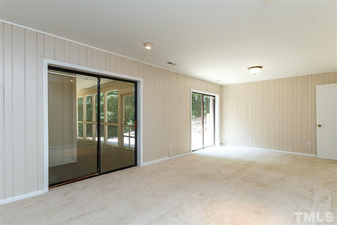 11604 Black Horse Run Raleigh, NC 27613 - Photo 15 of 29 a view of an empty room with glass door and windows